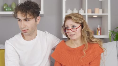 Young Adult Man Comforting an Adult Woman