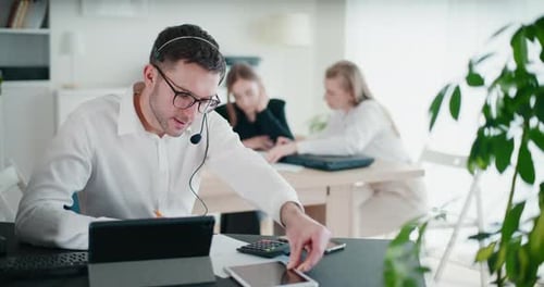Man With Headset Working in Bright Modern Office