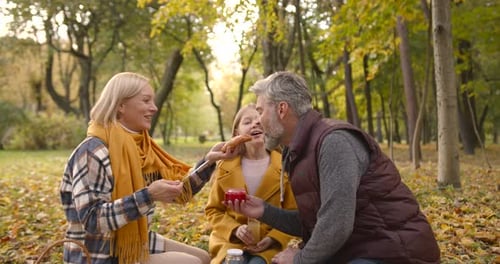 Family Picnic Together in an Autumn Park