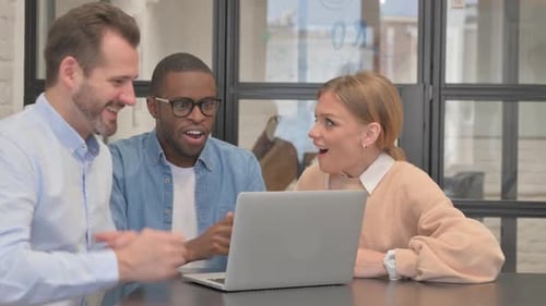 Excited Business People Celebrating Success in Office