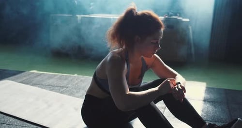 Woman Doing Crunches on a Yoga Mat in Gym