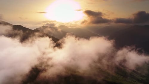 Droneshot flying above and through the clouds releasing the view on mountainrange and valleys in Aus