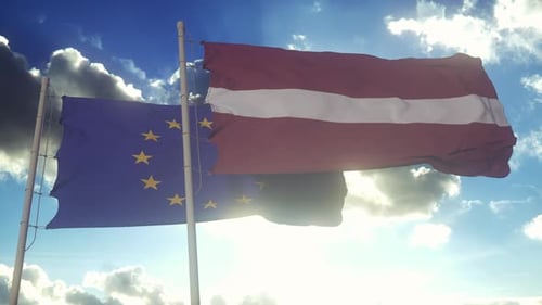 European Union and Latvia Flags Waving in Blue Sky