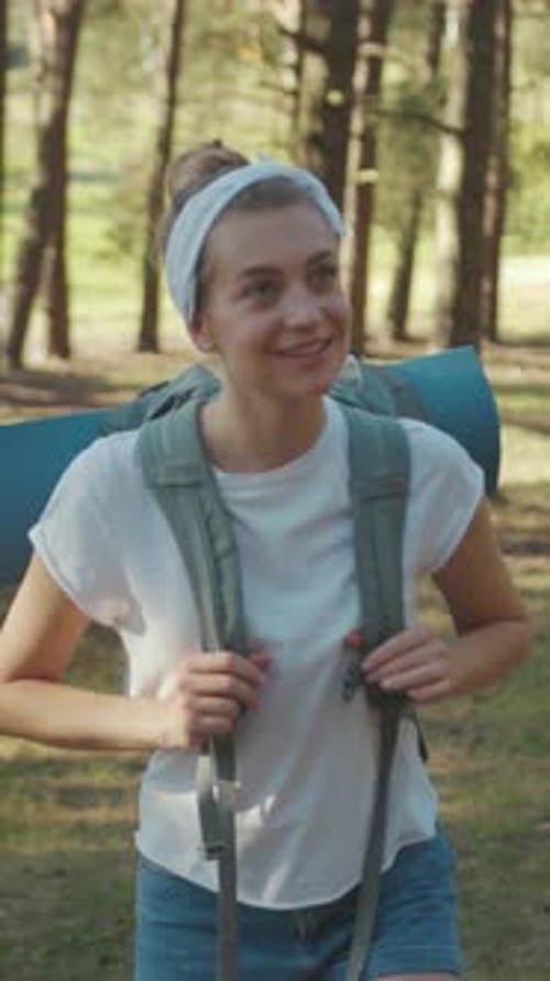Woman Hiking Through a Sunlit Forest