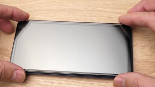 04. A new protective glass is pasted on the smartphone display. Mobile communication service.