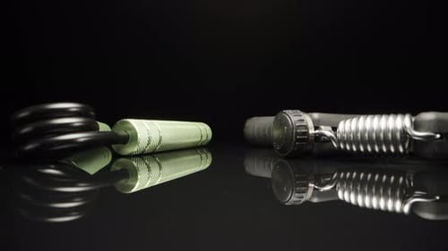 two hand trainers, expanders on a black background. Dolly slider extreme close-up. Laowa Probe