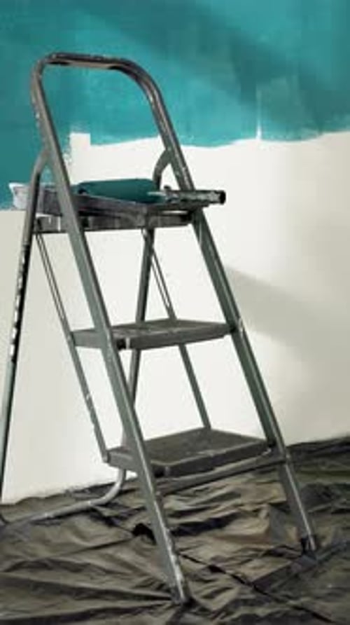 Creative, ladder and painting on wall with equipment, DIY project and renovation