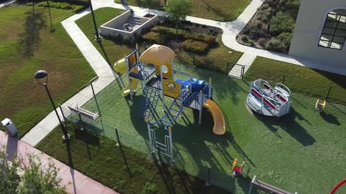 Low rotating shot showing a colorful children's playground and equipment