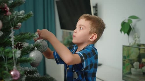 Boy Decorating Christmas Tree in Cozy Home