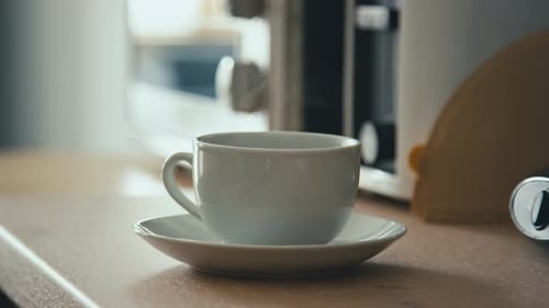 Close up of Steaming Coffee Cup Being Picked Up