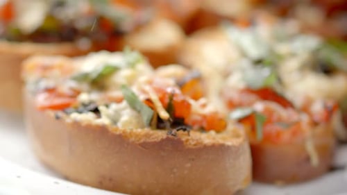 close up toasted bread brochetas with tomatoes, garlic, onion, Mediterranean diet, carbs