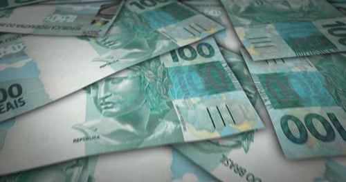 Brazil Real 100 banknote flying over money surface