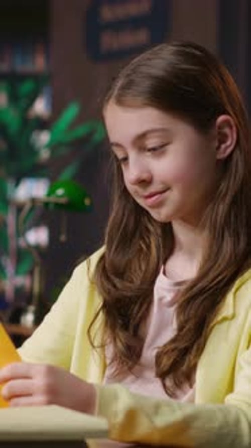Vertical Video Young Teen Girl Engrossed in Reading Books at the School Library