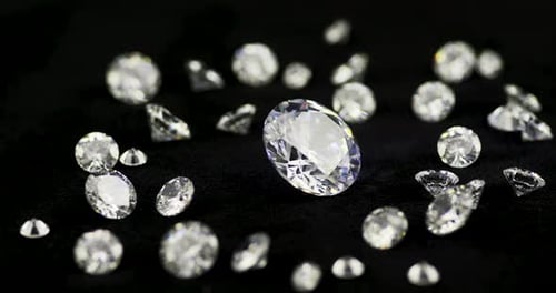Brilliant Diamonds Scattered on Black Surface Close Up