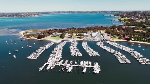 Aerial View of a Bustling Marina on a Sunny Day With Clear Blue Waters