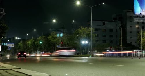 Night Timelapse shot of busy traffic of cars, taxis, buses, trucks, and other motorists at an inters