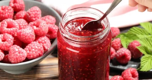 Raspberry Jam, spoon stirring jam in jar