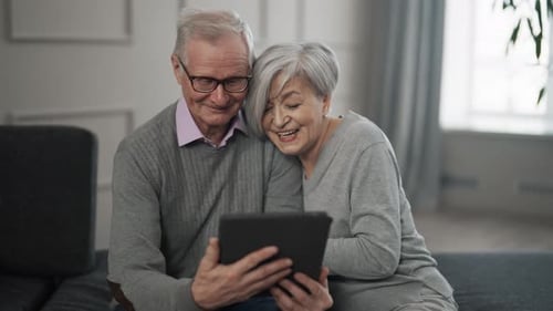 Senior Couple Watching Video on Tablet Happy Old Family Husband and Wife Watching Film Read News on