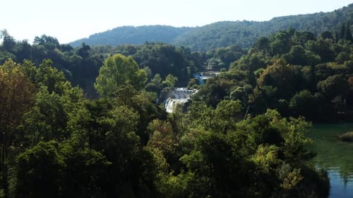 Flying Towards Skradinski Buk Waterfall With Tourists On Bridge In Krka National Park, Croatia. - ae