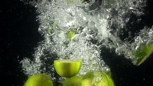 Limes Falling and Floating in Water