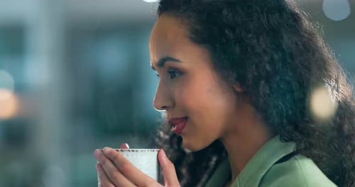 Woman Drinking from Mug Smiling at Workplace