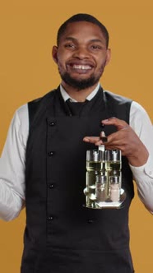 Vertical Video Restaurant Staff Showing Tablet with Green Screen Against Yellow Background
