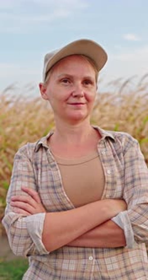 Confident Woman Farmer in Cornfield with Arms Crossed