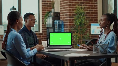 Workers Using Laptop with Green Screen