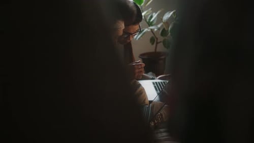 Two People Work on Laptop Indoors