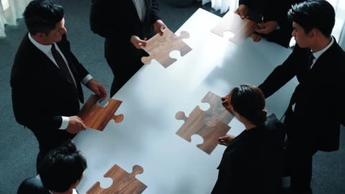 Top view of businesspeople putting jigsaw together at meeting room. Directorate.
