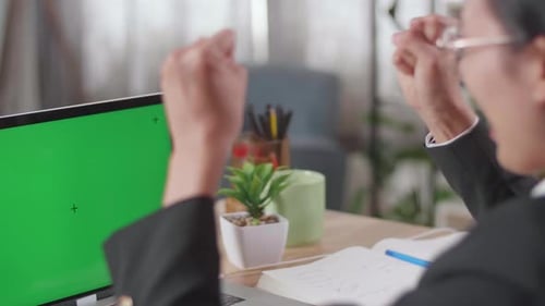 Close Up Of Asian Businesswoman With Green Screen Computer Being Happy Successful While Working