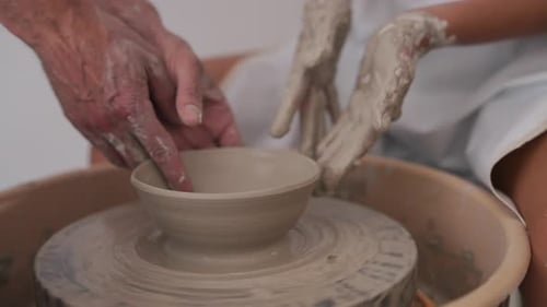 Potter Shapes Clay Bowl on Spinning Wheel