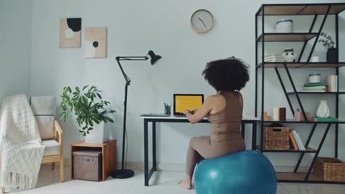 Woman Working at Home on Exercise Ball