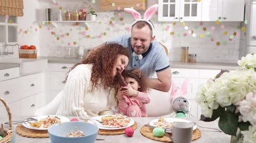 Family Celebrates Easter with Chocolate Bunny at Home