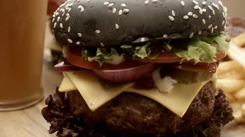 Tasty Burger with Black Bun, Cheese and Veggies