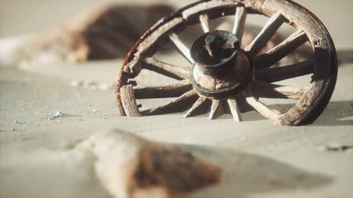 Old Wooden Wagon Wheel Half Buried in Desert Sand