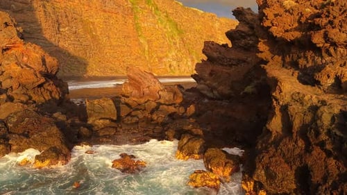 Golden Hour Envelops Rugged Cliffs and Crashing Waves on Canary Islands Highlighting a Breathtaking