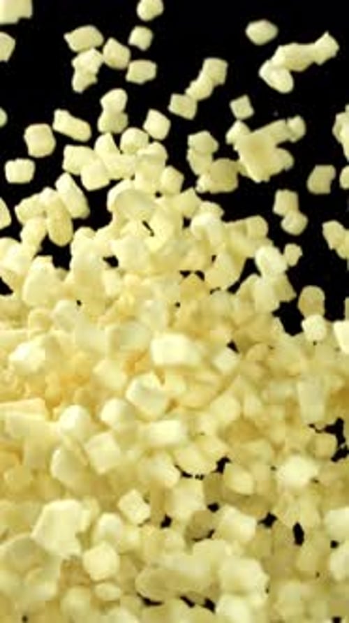 Mozzarella Cheese Flies Up and Falls Down on a Black Background Filmed on a Highspeed Camera at 1000