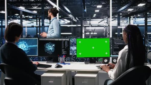 Female Technician and Coworker in Data Center Review AI Diagnostics on Mockup PC