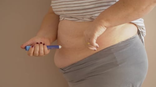 Adult Injecting Medicine into Abdomen