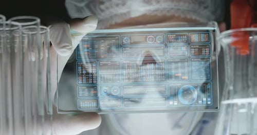Ein futuristischer Arzt, ein Chirurg, untersucht eine technologische digitale holographische Platte, eine medizinische m
