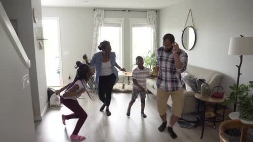 Happy Family Dancing Together in Living Room at Home