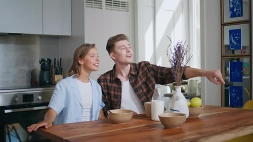 Spouses Have Fun Together in Morning Kitchen Loving Man Fooling Around Wife