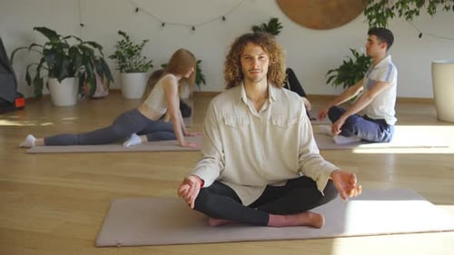 Join a Group Yoga Meditation Session in a Peaceful Studio Focusing on Balance Breathing Flexibility