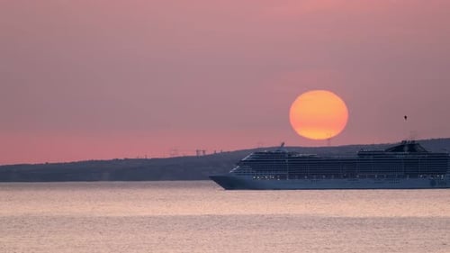Cruise Ship Sail in Sea on Sunset with Sun