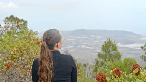 Girl with long hair looking over panorama of Tenerife, spectacular view