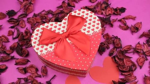 Heart Gift Box with Red Bow on Pink Surface