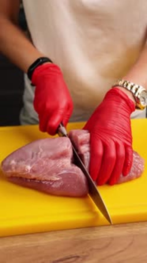 The chef prepares a dish of meat in the kitchen. Close-up