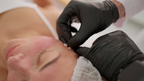 Woman Receives Cleansing Treatment on Forehead