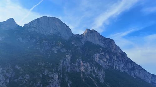 Majestic clouds gliding over towering mountain peaks